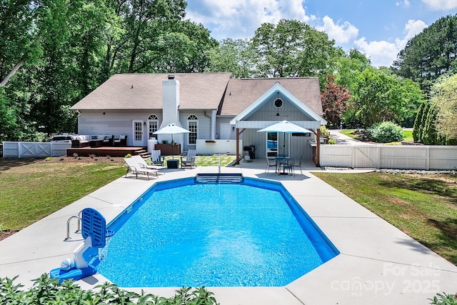 view of pool featuring an outdoor hangout area, a patio, a gate, and view of scattered trees