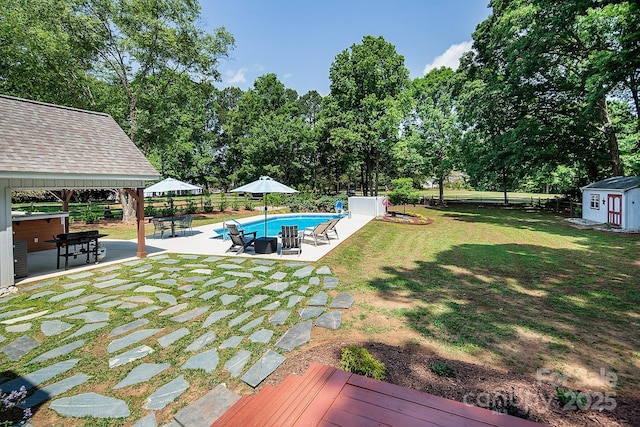 view of yard with a storage shed, an outdoor structure, a gazebo, a patio, and view of scattered trees