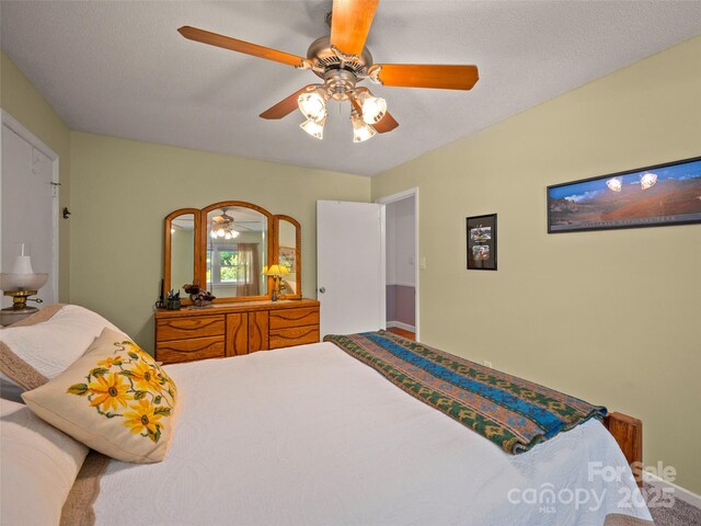 bedroom featuring carpet, ceiling fan, and baseboards