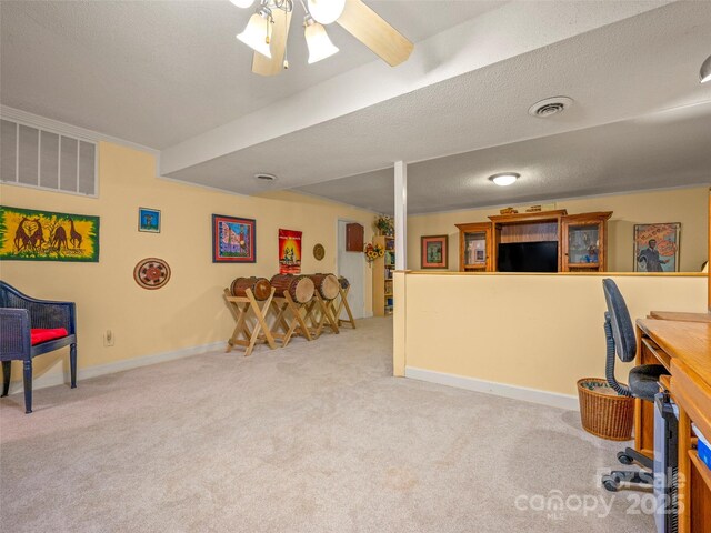 game room featuring carpet flooring, a textured ceiling, baseboards, ceiling fan, and an office area