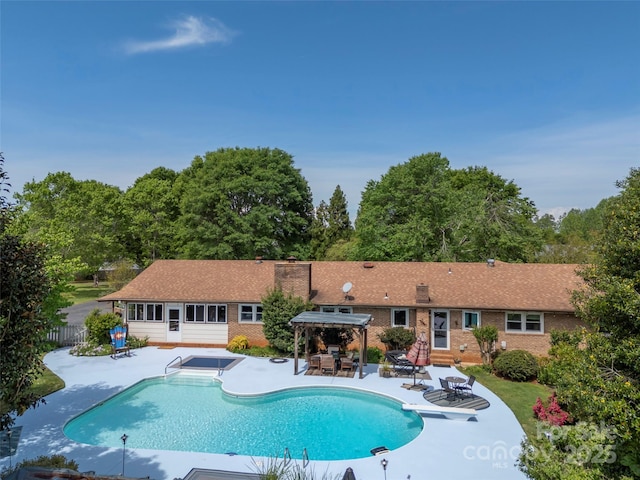 view of pool with a gazebo, a patio, fence, and a diving board