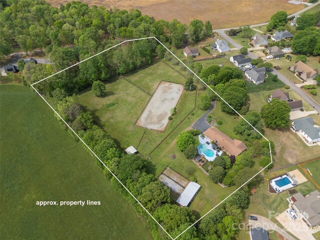 aerial overview of property's location featuring property parcel outlined and a pool area