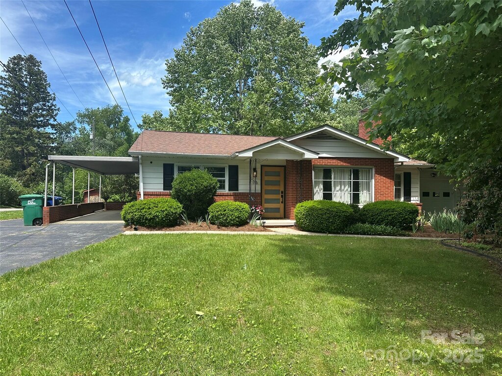 76 W Oakview Rd, Asheville, NC 28806 - single story home with brick siding, asphalt driveway, a front lawn, and a carport