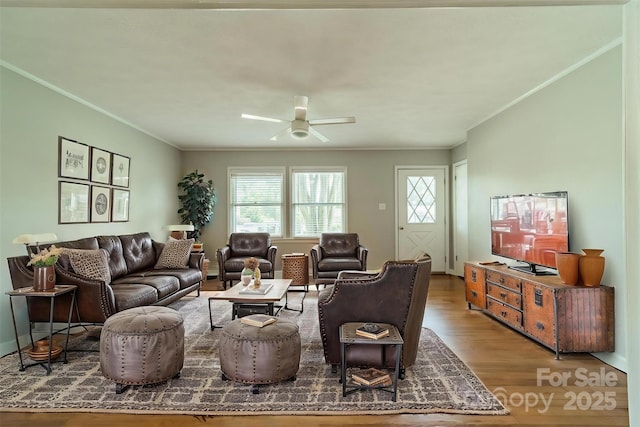 21614 Colina Dr, Cornelius, NC 28031 - living room featuring wood finished floors, healthy amount of natural light, crown molding, and a ceiling fan