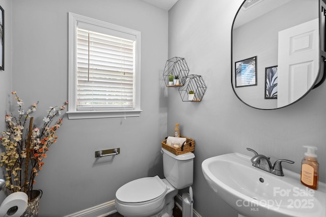 bathroom featuring a sink and toilet