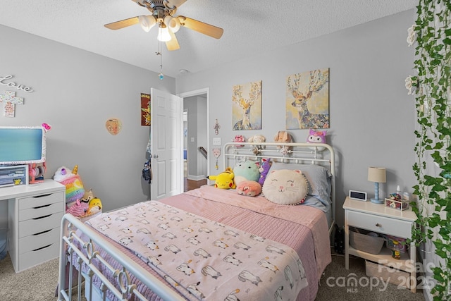 bedroom featuring carpet flooring, ceiling fan, and a textured ceiling