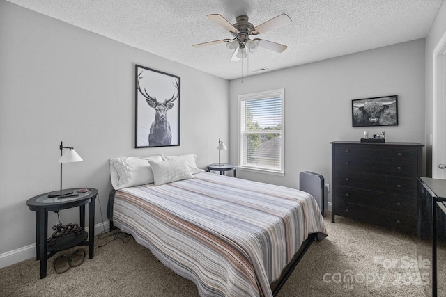 bedroom with light colored carpet, a textured ceiling, baseboards, and ceiling fan