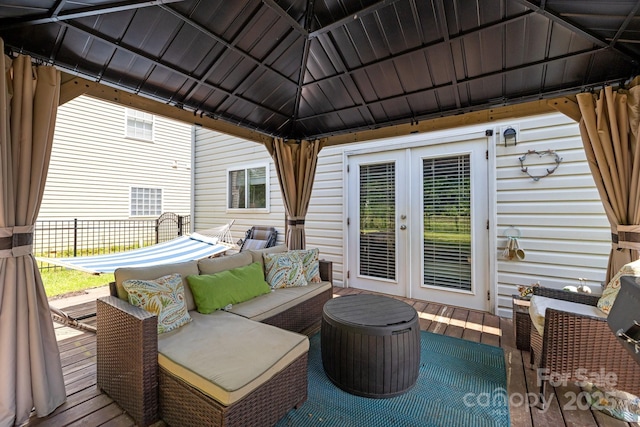 deck featuring a gazebo, french doors, and an outdoor living space