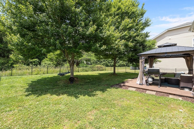 view of yard with a gazebo, a deck, and outdoor lounge area