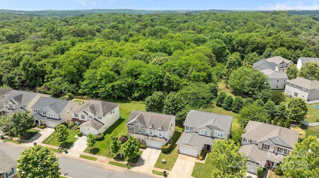 aerial perspective of suburban area with a heavily wooded area