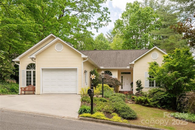 ranch-style home with driveway, a garage, and roof with shingles