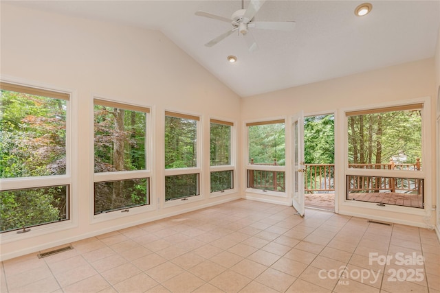 unfurnished sunroom featuring tile patterned flooring, high vaulted ceiling, recessed lighting, and healthy amount of natural light