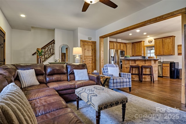 living room featuring a ceiling fan, dark wood finished floors, and recessed lighting