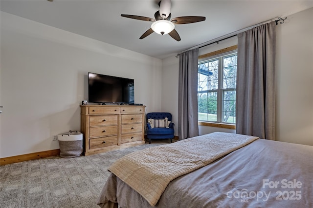 carpeted bedroom featuring baseboards and ceiling fan
