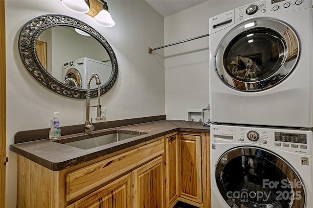 laundry room with stacked washer and clothes dryer and cabinet space