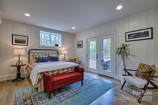 bedroom featuring multiple windows, access to outside, wood finished floors, french doors, and recessed lighting