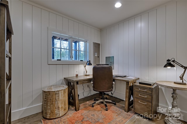 office with wood finished floors and electric panel