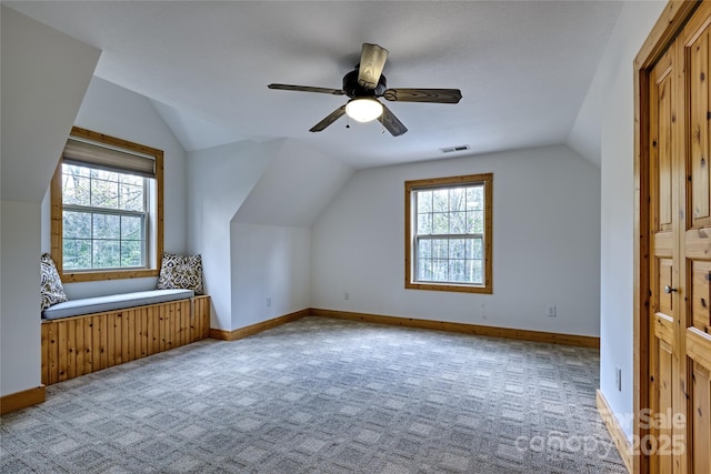 additional living space featuring vaulted ceiling, carpet flooring, ceiling fan, and baseboards