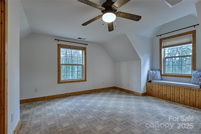 bonus room with vaulted ceiling, carpet, a ceiling fan, and baseboards