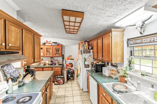 4155 Slanting Bridge Rd, Sherrills Ford, NC 28673 - kitchen featuring washer and clothes dryer, white appliances, brown cabinets, a sink, and light tile patterned floors