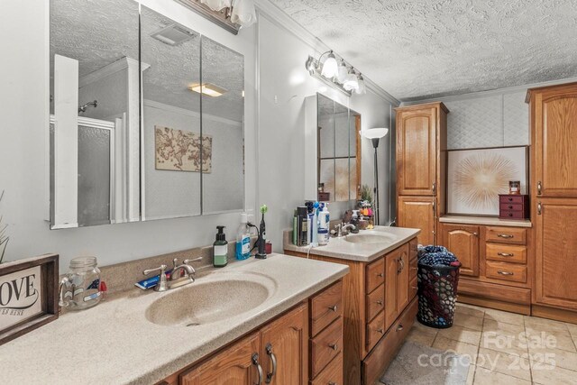 4155 Slanting Bridge Rd, Sherrills Ford, NC 28673 - bathroom with a textured ceiling, ornamental molding, two vanities, and tile patterned flooring