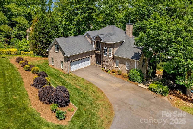 141 Ridge Top Rd, Mooresville, NC 28117 - traditional-style home with driveway, a chimney, a front lawn, a garage, and stone siding