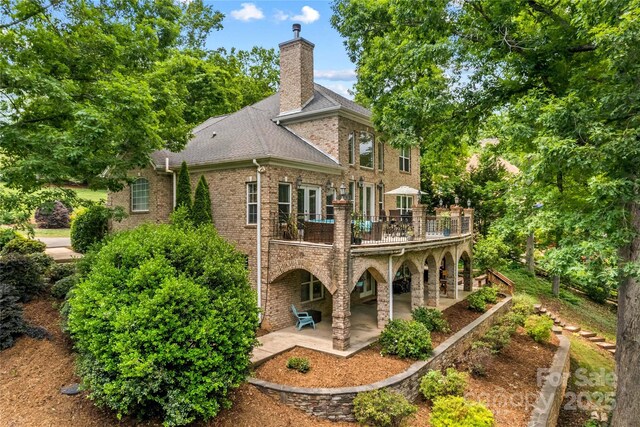 141 Ridge Top Rd, Mooresville, NC 28117 - rear view of house featuring a patio, a chimney, brick siding, and a deck