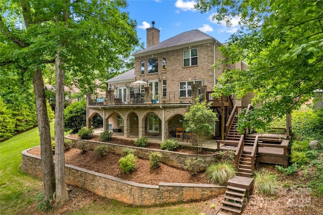 141 Ridge Top Rd, Mooresville, NC 28117 - back of house with stairway, a chimney, a patio, a deck, and brick siding