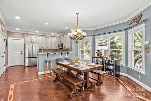 141 Ridge Top Rd, Mooresville, NC 28117 - dining space with a chandelier, dark wood-style flooring, crown molding, recessed lighting, and baseboards