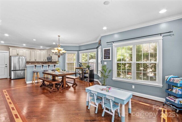 141 Ridge Top Rd, Mooresville, NC 28117 - dining room featuring a chandelier, dark wood-style floors, recessed lighting, ornamental molding, and baseboards