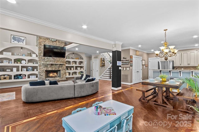 141 Ridge Top Rd, Mooresville, NC 28117 - living area with ornamental molding, dark wood finished floors, stairs, a fireplace, and baseboards