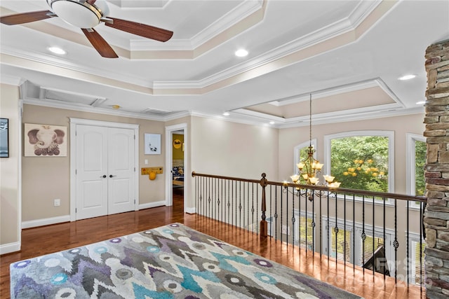 141 Ridge Top Rd, Mooresville, NC 28117 - living area featuring crown molding, wood finished floors, a raised ceiling, a ceiling fan, and a chandelier
