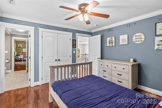 141 Ridge Top Rd, Mooresville, NC 28117 - bedroom with crown molding, baseboards, wood finished floors, ceiling fan, and a closet