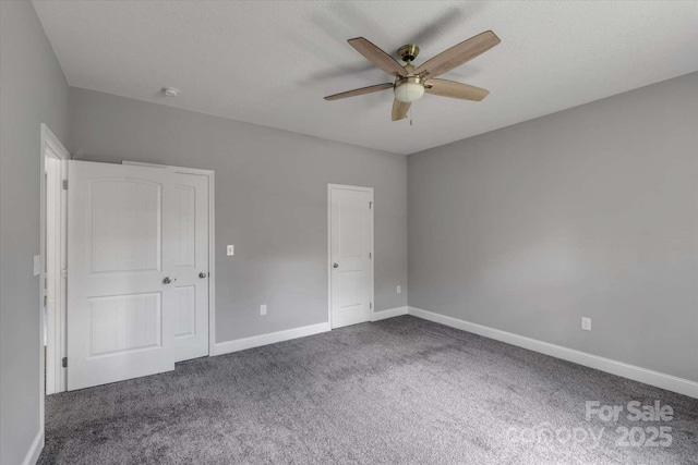 unfurnished bedroom with carpet, baseboards, and ceiling fan