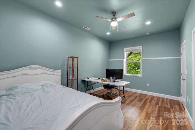 bedroom featuring wood finished floors, recessed lighting, baseboards, an office area, and ceiling fan