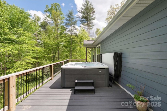wooden terrace featuring a hot tub