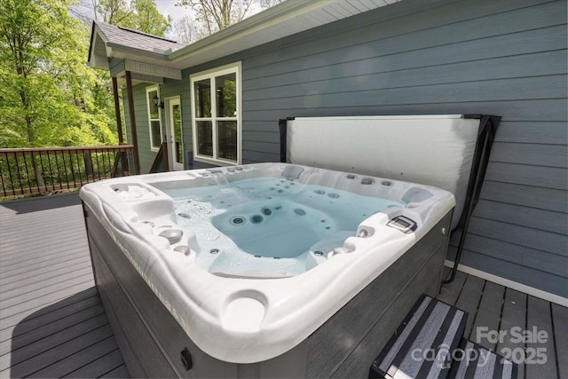 wooden terrace featuring a covered hot tub