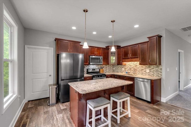 36 Nader Ave, Weaverville, NC 28787 - kitchen featuring appliances with stainless steel finishes, healthy amount of natural light, decorative backsplash, a kitchen island, and recessed lighting