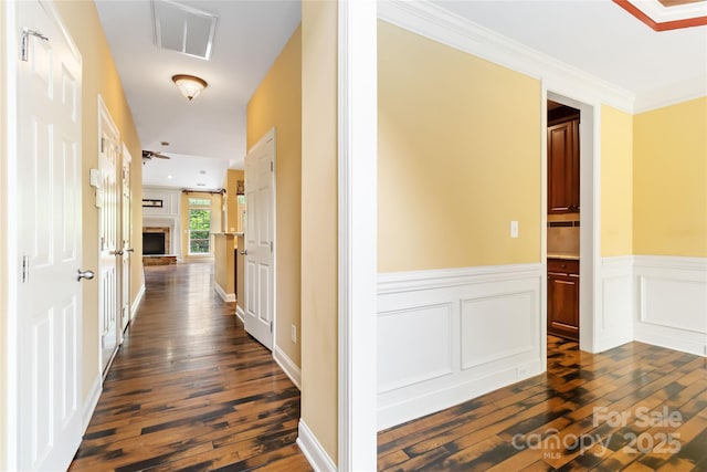 2346 Donnington Ln NW, Concord, NC 28027 - hallway with dark wood-style flooring, a wainscoted wall, and crown molding