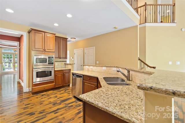 2346 Donnington Ln NW, Concord, NC 28027 - kitchen featuring appliances with stainless steel finishes, a sink, dark wood-type flooring, recessed lighting, and light stone counters
