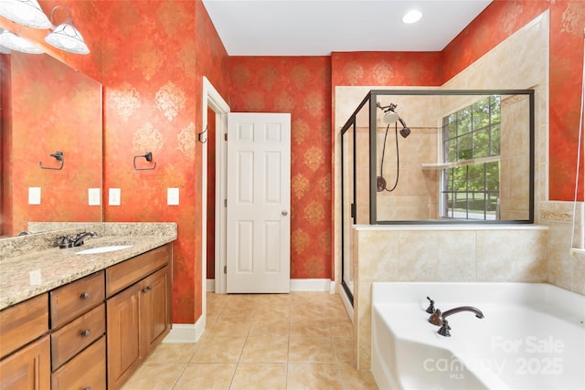 2346 Donnington Ln NW, Concord, NC 28027 - bathroom featuring a stall shower, a garden tub, vanity, tile patterned flooring, and baseboards