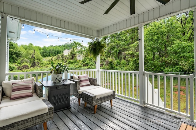 wooden terrace with ceiling fan and an outdoor hangout area
