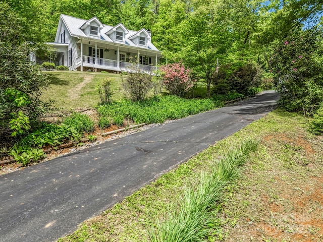 view of front of home featuring covered porch and a front yard