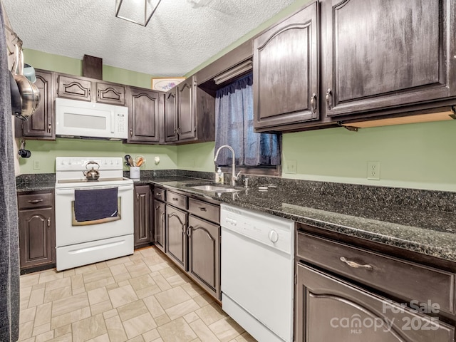 kitchen with white appliances, a sink, dark brown cabinets, a textured ceiling, and dark stone counters
