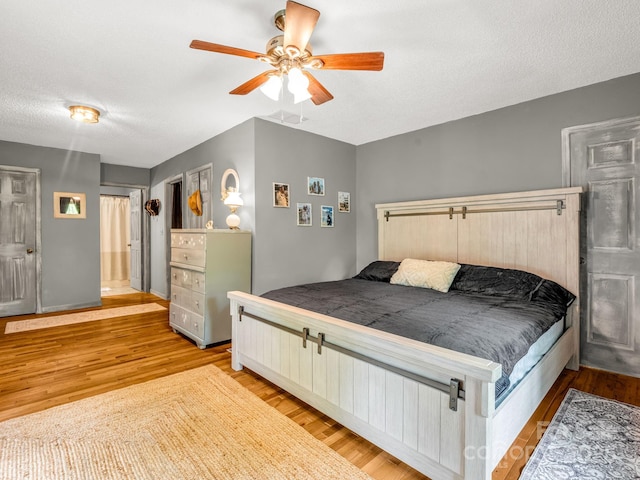 bedroom featuring wood finished floors, ceiling fan, and baseboards