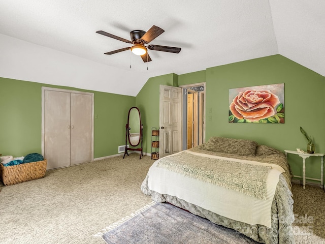 carpeted bedroom with lofted ceiling, baseboards, ceiling fan, and a closet