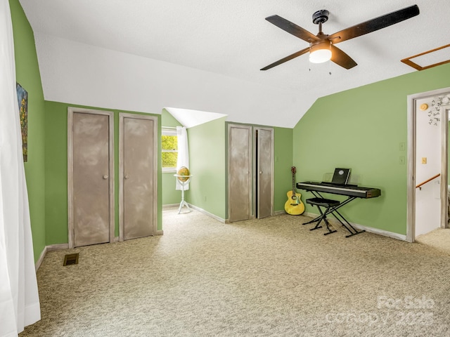 bedroom featuring lofted ceiling, carpet flooring, baseboards, and ceiling fan