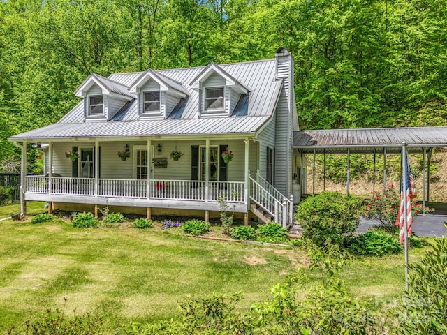 view of front of house with a porch, a chimney, metal roof, and a front yard