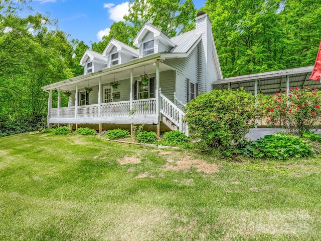 cape cod house featuring a porch, a front yard, and a chimney