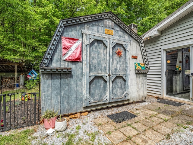view of shed with fence